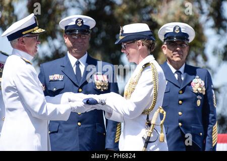 Konteradmiral Todd Sokalzuk, Bezirk Kommandant der Küstenwache, die Hände seiner persönlichen Flagge zu seinem Adjutanten, Lt Julia Kane, während seiner Change-of-Befehl Zeremonie an der Coast Guard Island in Alameda, Kalifornien, 28. Juni 2018, als aktive und Reserve Command Master Chiefs. Während der Zeremonie, Konteradmiral Peter Gautier ersetzt Sokalzuk als der Bezirk Commander als Sokalzuk Köpfe an die Ostküste der stellvertretende Kommandeur der Küstenwache Atlantischen Gebiet. Stockfoto