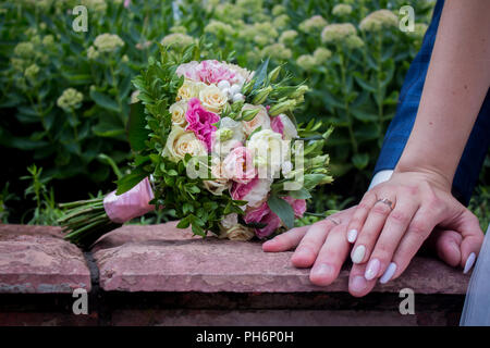 Nahaufnahme der Bräutigam die Hand Braut wirst Ausschreibung, Blume, Jungvermählt, Kirche Stockfoto