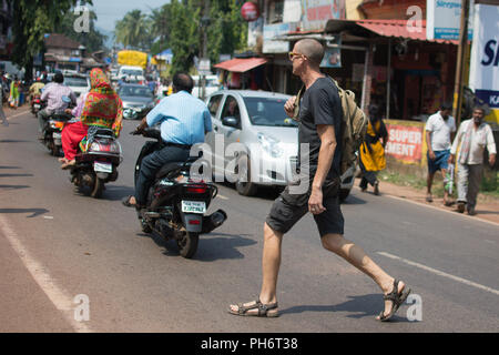 Goa, Indien - 8. Juli 2018 - Europäische Mann in typische Verkehrssituation auf indischen Straße in Canacona - Goa Stockfoto