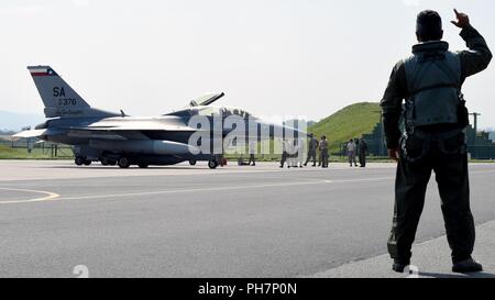 Oberst Raul Rosario, Kommandant der 149 Operations Group, Air National Guard, gibt der Gunfighter salute während Sky Avenger 2018 zu einer anderen F-16 Fighter Pilot in Čáslav Air Base in der Tschechischen Republik am 29. Juni. (Air National Guard Stockfoto