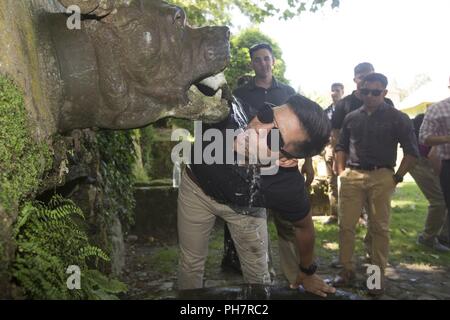 Us Marine Corps Lance Cpl. Anthony Chaidez mit 2. Air Naval Geschützfeuer Liaison Firma Getränke von der Devil Dog Brunnen während einer Tour von der Schlacht von Belleau Wood bei Belleau, Frankreich, 29. Juni 2018. Stockfoto