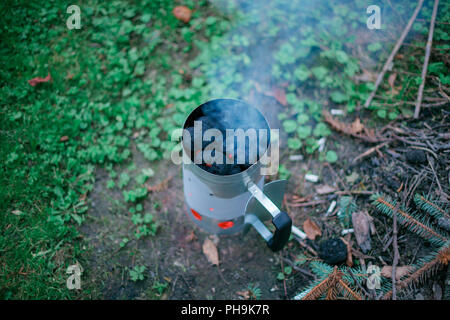 Feuern Sie Holzkohle vor dem Grill mit Kohle Chimney Starter Stockfoto