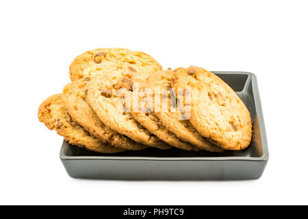Milch Schokolade Mandel Cookies in schwarze Platte Stockfoto