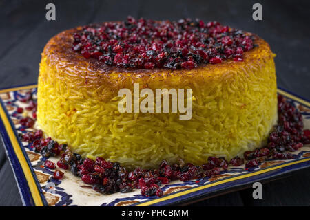 Traditionelle iranische Reis Torte Tahdig mit Berberis auf einer Platte Stockfoto