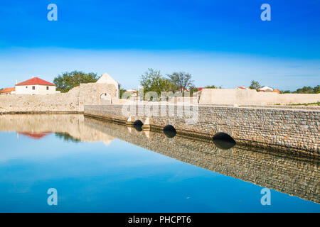 Alte steinerne Brücke und oberen Stadttor in der mittelalterlichen Altstadt von Nin, Dalmatien, Kroatien Stockfoto