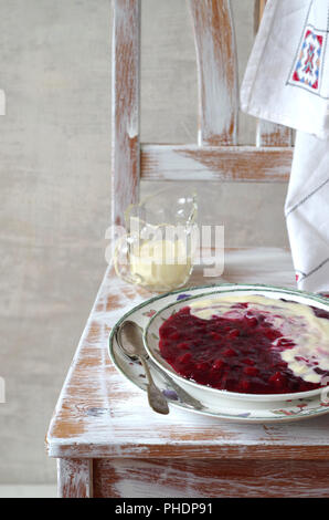 Rotbeerenkompott mit Vanillesoße Stockfoto