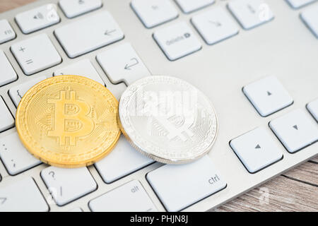 Goldene und Silberne bitcoins auf einer Tastatur Stockfoto