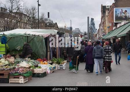 Anzeigen von Kunden- und Marktständen in der Whitechapel Road, Tower Hamlets, East London, in Richtung der Gurke (30 St Mary Axe) und der Stadt, 2016. Stockfoto