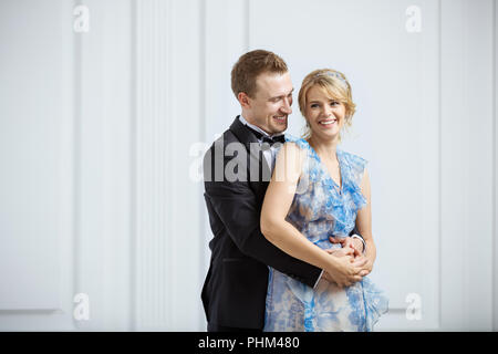 Junges Paar in Luxus modischer Kleidung umarmen und Lachen im Innenbereich Stockfoto