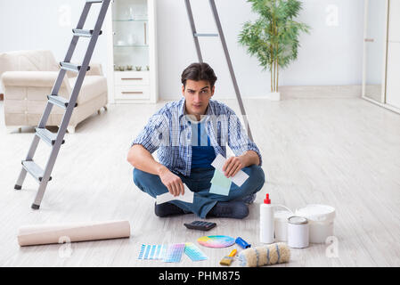 Junger Mann verschwenden sein Budget in der Sanierung Projekt Stockfoto