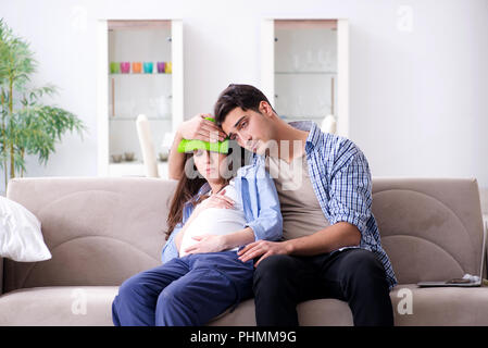 Schwangere Frau mit Mann zu Hause Stockfoto