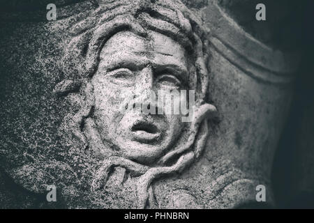 Statue Detail Nahaufnahme eines verwitterten Stein Grimasse Stockfoto