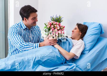 Pflege liebevoller Ehemann besuchen schwangere Frau im Krankenhaus Stockfoto