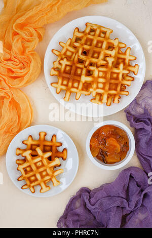 Blick von oben auf die Belgischen Waffeln auf beige Tabelle. Stockfoto