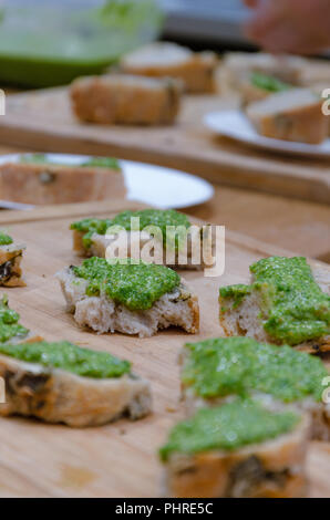 Frisch gebackenes Brot und Basilikum Pesto auf braune Holztisch Stockfoto