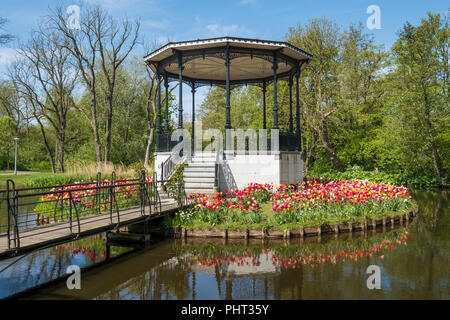 Brücke mit schönen park Kiosk und Tulpen im Vondelpark in Amsterdam, Niederlande Stockfoto