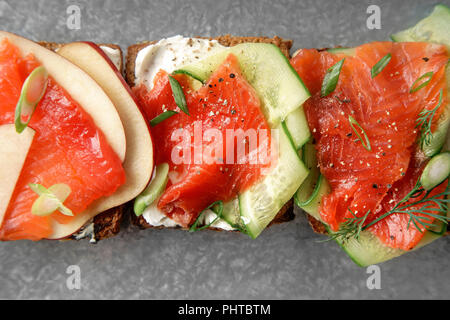 Dänische traditionelle Snack smorrebrod mit Lachs, Gurken und Frischkäse Stockfoto