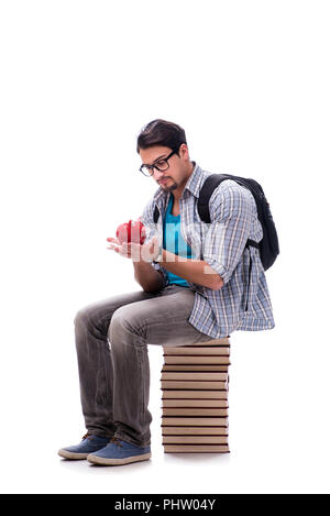 Junge Studentin auf Buch sitzen Stack auf Weiß Stockfoto