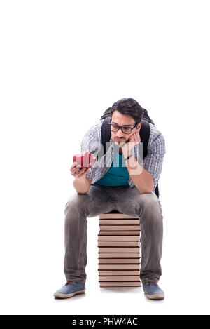 Junge Studentin auf Buch sitzen Stack auf Weiß Stockfoto