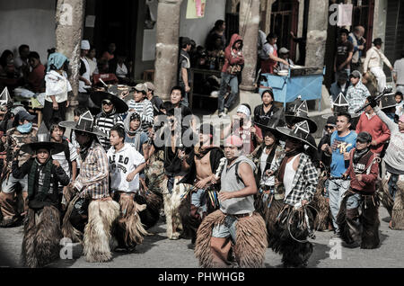 Indigenen Männer aus den umliegenden Gemeinden März in den Straßen während der Inti Raymi feiern in Cotacachi, Ecuador Stockfoto