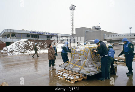 4. März 1993 während der Belagerung von Sarajevo: am Flughafen von Sarajevo, eine UN-Soldaten und UN-Polizisten unterschiedlicher Nationalitäten prüfen eine große Palette, die gerade mit dem Flugzeug angekommen ist. Stockfoto