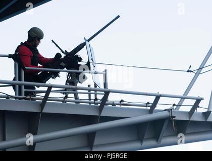 180825-N-TT 202-194 ATLANTIK (Aug. 25, 2018) von Gunner Mate 2. Klasse Maan Alquran, von Spartanburg, South Carolina, bereitet ein.50-Kaliber Maschinengewehr für ein Training auf dem fantail der Nimitz-Klasse Flugzeugträger USS Abraham Lincoln (CVN 72). Abraham Lincoln wird derzeit die Durchführung von Carrier Qualifikationen. (U.S. Marine Foto von Mass Communication Specialist 3. Klasse Daniel E. Gheesling/Freigegeben) Stockfoto