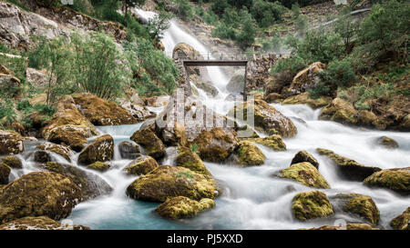 Brücke über Wasser vom Briksdal Gletscher Jostedalsbreen Nationalpark, Norwegen fließende Stockfoto