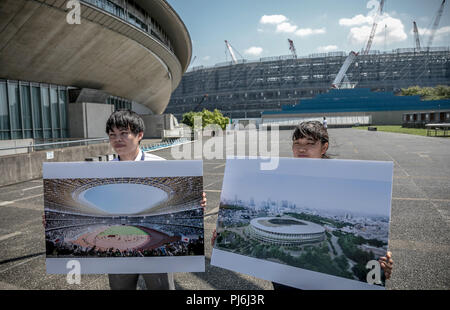 Tokio, Japan. 05 Sep, 2018. 05.09.2018, Tokyo, Japan: Helfer anzeigen Zeigt mit einer Simulation der neuen Bau des Olympiastadions für die Olympischen Sommerspiele 2020 in Tokio vor dem Stadion Baustelle. Fast zwei Jahre vor der nächsten Spiele, die Veranstalter präsentierten den Stand der Vorbereitungen für die Übereinstimmungen mit der internationalen Medien. Die ultra-modernen Tokyo Bay Zone wird der Mittelpunkt der Sommerspiele. Medaillen werden in 33 Sportarten vergeben, plus Baseball/Softball, Karate, Skateboard, Sport Klettern und Surfen. Quelle: Michael Kappeler/dpa/Alamy leben Nachrichten Stockfoto