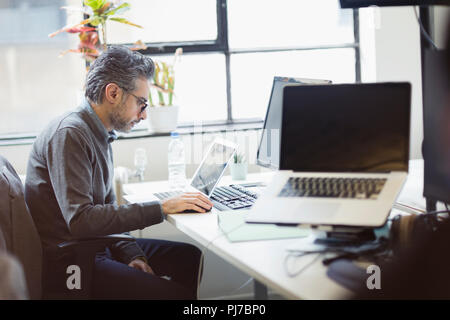 Geschäftsmann, arbeiten am Laptop im Büro konzentriert Stockfoto
