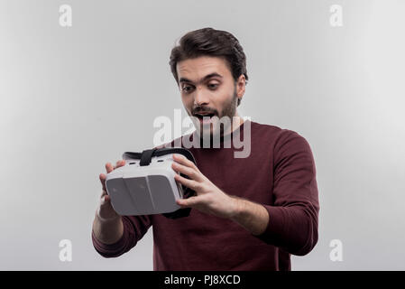 Junge aufgeregt Mann seine neue virtuelle Realität halten Gläser Stockfoto