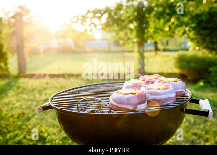 Die hausgemachte Bier kann Bacon Burger am Grill zubereitet. Vorbereitung gefüllte Pastetchen, in Speck umwickelt und Grillen auf indirekte Hitze in der Natur an der Bac Stockfoto