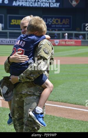 Air Force Tech Sgt. Andrea Carrothers mit 148 der Minnesota Air National Guard Fighter Wing vereint mit ihrem Sohn, William, auf Feld während der Minnesota Twins Streitkräfte Anerkennung Tag Spiel 2018. Der Minnesota Twins anerkannten Service Mitglieder und Veteranen während ihrer jährlichen Streitkräfte Anerkennung Tag Spiel, 8. Juli 2018, im Zielfeld. (Minnesota National Guard Stockfoto