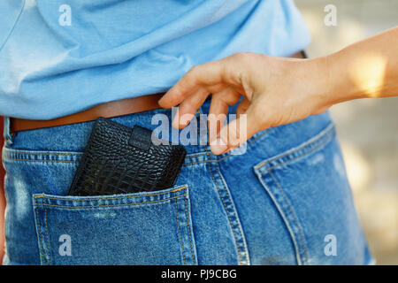 Diebstahl einer Geldbörse aus seiner Tasche, in der Sie tagsüber auf der Straße, close-up Stockfoto