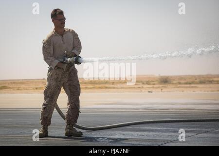 Unbekannten ORT, NAHER OSTEN - US Marine Corps Cpl. Seth Brummer, eine Bekämpfung der Ingenieur mit Marine Wing Support Squadron 371, Special Purpose Marine Air-Ground Task Force angebracht, Krise Response-Central Befehl reinigt aus einem Abschnitt der Zement während der Reparatur eines beschädigten Flugplatz Juli 3, 2018. Der Flugplatz Schäden reparieren Team sorgt für Start- und Landebahnen sicher sind Flugbetrieb in der gesamten Region durchzuführen. Stockfoto