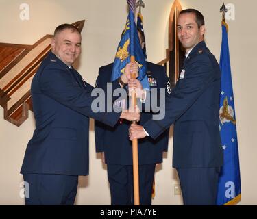 Us Air Force Colonel Matthew Jefson, 325 Mission Support Group Commander (links), übergibt die zeremoniellen Guidon, Maj. Jesse D. Calland, eingehende 325 Force Support Squadron Commander (rechts), während eine änderung - von - Befehl Zeremonie am Tyndall Air Force Base, Fla., 2. Juli 2018. Die Staffel bietet Manpower, Personal, Gemeinschaft Erhaltung Dienstleistungen, Bildung und Ausbildung in den 325 Fighter Wing und 40 assoziierten Einheiten. Stockfoto