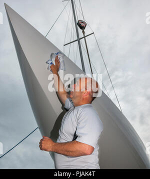 Union Hall, Irland. 6. September 2018. Crew Mitglied Simon Furney, Kinsale Polieren der Rumpf der Yacht Little Fella in der Union Halle in Vorbereitung des Nationalen irischen Dragon Meisterschaften an Glandore, Co.Cork gehalten zu werden. - David Creedon/Alamy leben Nachrichten Stockfoto