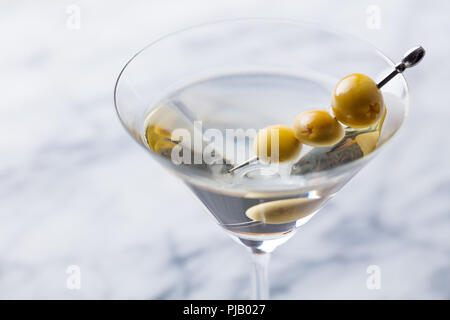 Martini Cocktail mit grünen Oliven auf Marmor. Close Up. Stockfoto