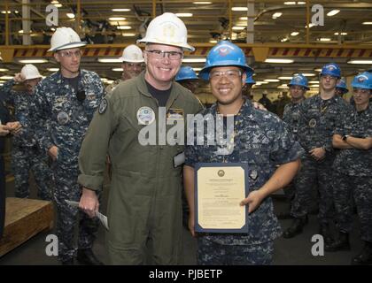 NORFOLK, Virginia (9. Juli 2018) Der Bootsmann Mate 2. Klasse allen Jen, aus San Jose, Kalifornien, zu USS Gerald R. Ford's (CVN 78) deck Abteilung zugewiesen, erhält seine Ernennungsurkunde in den Rang eines Petty Officer Second class von Kapitän Richard McCormack, Ford's kommandierender Offizier. Jen war nach seiner Auswahl für die verdienstvolle Förderung Programm gefördert. Stockfoto