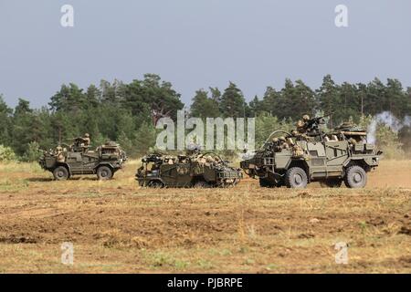 Britischen Armee "Coyote" taktische Unterstützung Fahrzeug mit der 1 Queen's Dragoon Guards Feuer an Feinde während der Polnischen 15 mechanisierte Brigade's Tank Tag Feier mit der Battle Group Polen Orzysz, Polen am 14. Juli 2018. Battle Group Polen ist ein einzigartiges, multinationale Koalition von USA, Großbritannien, Kroatischen und rumänischen Soldaten, die mit der polnischen 15 mechanisierte Brigade als Abschreckung Kraft zur Unterstützung des NATO-Enhanced vorwärts Präsenz dienen. Stockfoto