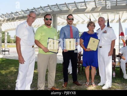 JACKSONVILLE, Fla. (Juli 13, 2018) von links nach rechts, Command Master Chief Donald Henderson posiert für ein Foto mit seinen Söhnen, seiner Frau und Flotte Bereitschaft Zentrum Südost befehlshabenden Offizier, Kapitän Trent DeMoss. Henderson zog sich von der Marine nach 30 Jahren der Herr Abgeordnete Service. Stockfoto