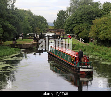 Die schmalen Boot "REIHERENTE" ist die Eingabe der 2. Sperre eines langen Flug von Sperren der Abstieg zu beginnen auf dem Leeds und Liverpool Canal in Wigan. Stockfoto