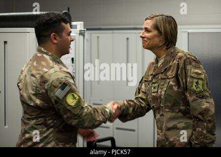 Kol. Jennifer Kurz, rechts, 23d Wing Commander, Münzen Staff Sgt. Michael Triana, 347 Operations Support Squadron (OSS) unabhängige Aufgabe medizinischer Techniker (IDMT) Sanitäter, während ein Eintauchen tour, 23. Juli 2018, bei Moody Air Force Base, Ga während der Immersion, Kurz besucht mit Survival, Evasion, Widerstand, Flucht (SERE) und medizinischen Spezialisten aus der 347 OSS. Die 347 OSS Rescue Training Center beide Häuser IDMT Sanitäter und SERE Spezialisten, deren Aufgabe es ist, Bahn und Flieger ausstatten, um überleben zu können und Leben zu retten, während im kargen Umgebungen. Stockfoto