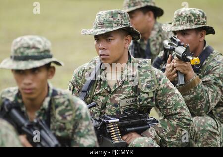 Soldaten mit dem 15 Royal Malay Regiment simulieren ein Dschungel Hinterhalt während der Übung Keris Streik, Juli 24, 2018, Camp Senawang, Malaysia. Malaysischen Soldaten beweisen ihre Dschungel Taktiken zur Vorbereitung der Keris Streik jungle Bereich Training. Stockfoto