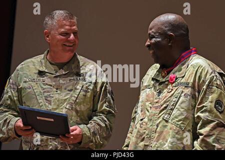 Command Sgt. Maj. Dennis Sapp, ehemaliger Louisiana Army National Guard senior Advisor eingetragen (rechts) und Generalmajor Glenn H. Curtis, Adjutant General der Louisiana National Guard (links), teilen sich ein Lachen während Erinnerungen auf der Sapp Karriere während seiner Pensionierung Zeremonie im Camp Beauregard in Pineville, Louisiana, 14. Juli 2018. Sapp trat der US-Army in 1978 und der LANG im Jahr 1993, in dem insgesamt 39 Jahre in der Armee. Stockfoto