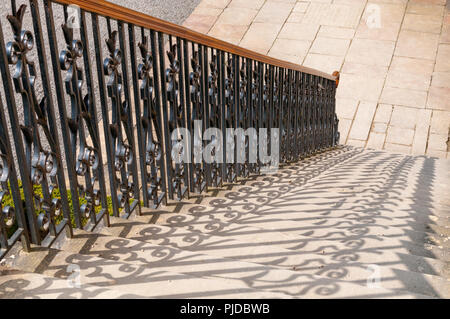 Schatten der dekorativen gegossen Baluster auf Stein Schritte Stockfoto