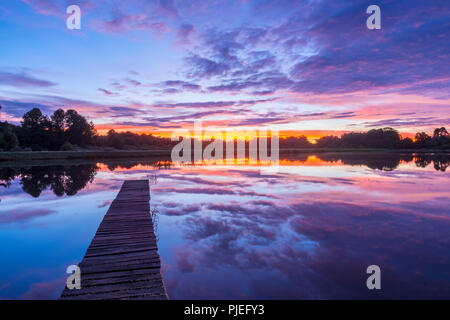 Ein bunter Sonnenaufgang über s Pier an der Connemara Seen, Nyanga Simbabwe gesehen. Stockfoto