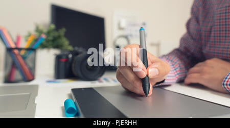 Grafik Designer arbeiten an digitalen Tablet. Kamera auf den Schreibtisch im Hintergrund. Fotograf im Büro arbeiten. Stockfoto