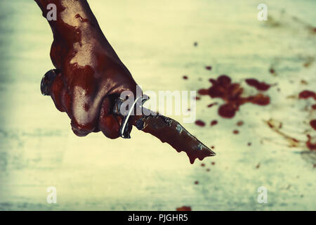 Blutigen stechen. Hand mit Messer Messer, horror Blut. Scharfe Waffen in der Hand der Slayer. Stockfoto