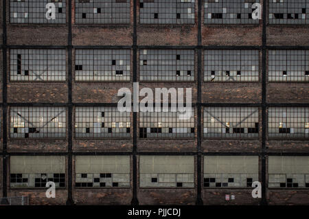 Zerbrochene Fenster in einer großen Mauer einer Fabrik am Bethlehem Stahlwerk in Pennsylvania. Stockfoto