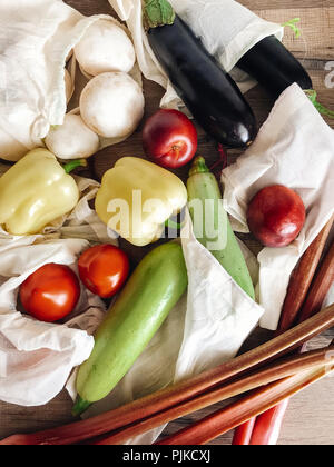 Null Abfall shopping Konzept. frisches Gemüse im eco Baumwolle Taschen am Tisch in der Küche, flach. verbot Kunststoff Kunststoff freie Einzelteile. Umwelt speichern Stockfoto
